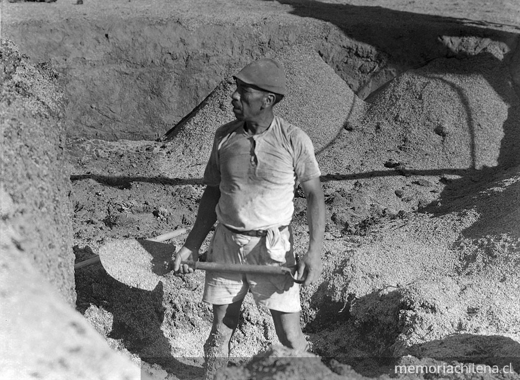 Hombre trabajando con una pala en la arena