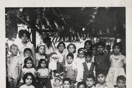 Pie de foto: Grupo de niños y niñas posando con el viejito pascuero