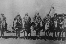 Grupo de hombres mapuche montados a caballo